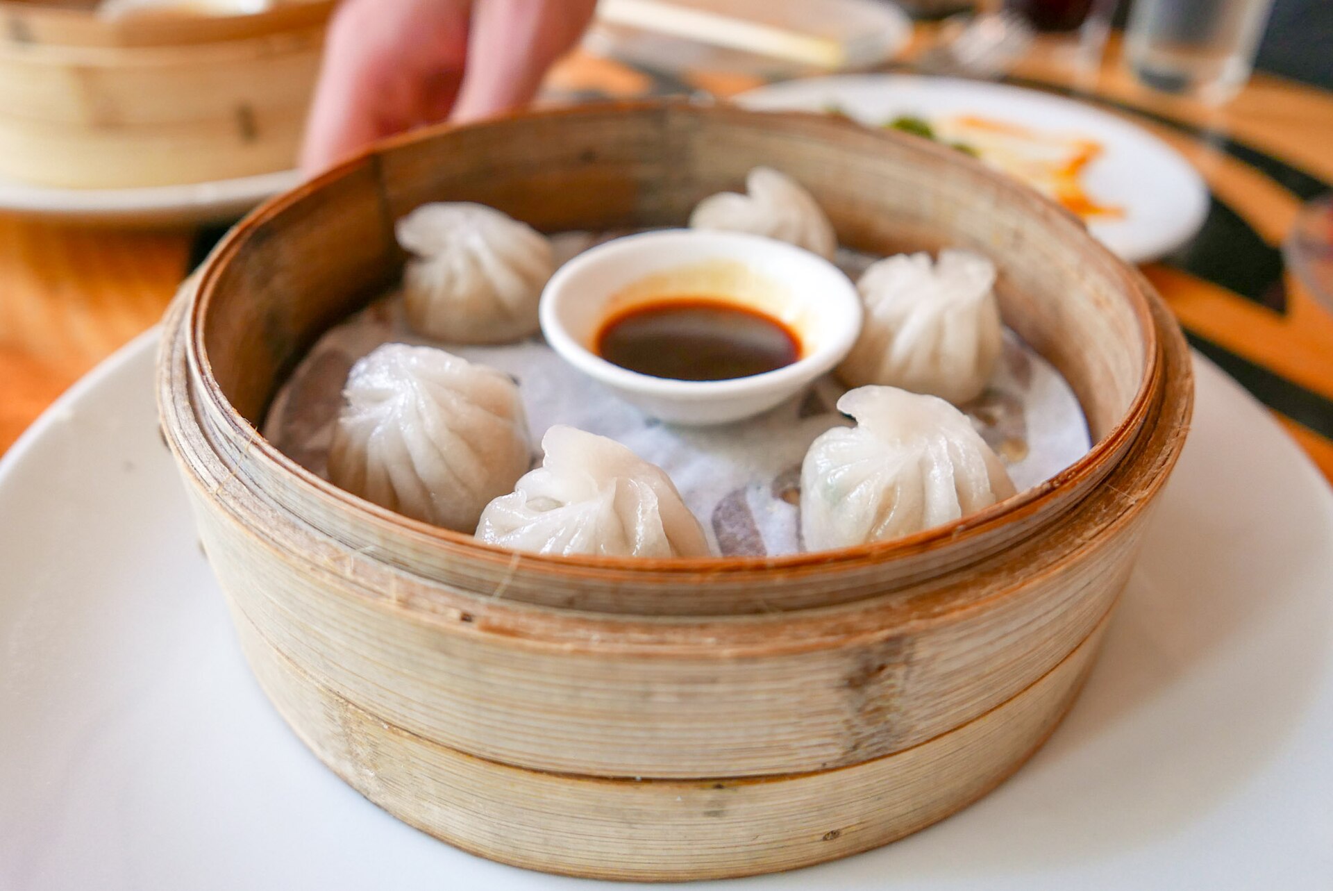 Xiao long bao soup dumplings with ginger and vinegar at a Chinatown Singapore restaurant